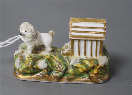 A rare Staffordshire porcelain figure a poodle outside its kennel, c.1835-50, attributed to Lloyd Shelton, L. 8cm